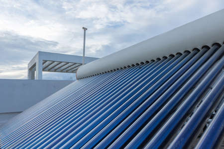 solar panels and tubes installed on roof top of houses and buildings to conserve energyの写真素材