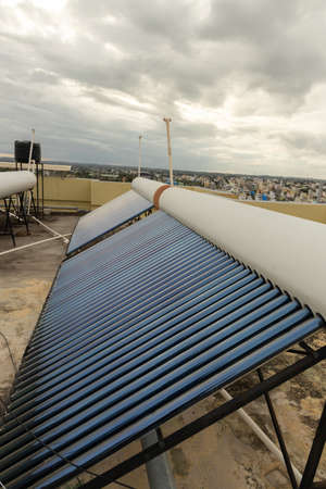 solar panels and tubes installed on roof top of houses and buildings to conserve energy