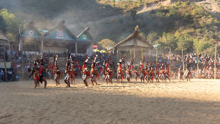 Selective focus image of a group of naga tribesmen dressed in their traditional attire dancing during Hornbill festival in Nagaland India on 4 December 2016のeditorial素材