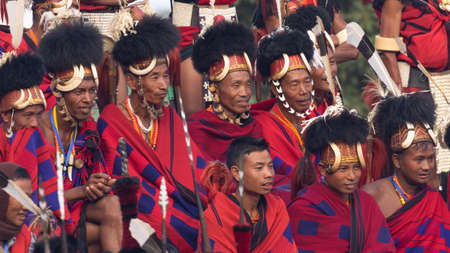 Naga Tribesmen siting dressed in traditional warrior attire at Kisama village in Nagaland India on 3 December 2016のeditorial素材