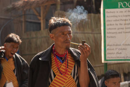 A Naga Tribesman smoking a pipe at Kisama village in Nagaland India on 2 December 2016のeditorial素材