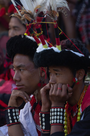 A young Naga boy wearing a hornbill feather headgear at Kisama Heritage village in Nagaland India on 3 December 2016のeditorial素材