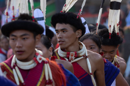Selective focus image of a Young Naga tribesmen wearing traditional attire at central arena of Kisama Village in Nagaland India on 2 December 2016のeditorial素材