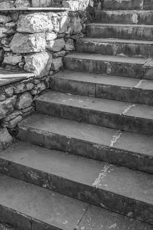 An abstract pattern in monochrome of the staircase and a side wall made of stonesの写真素材