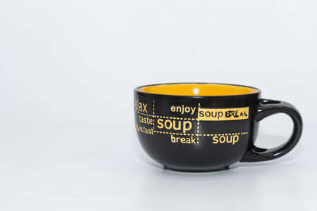A ceramic soup bowl or soup mug with handle and plane white background
