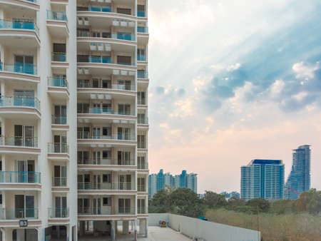 A close up glimpse of a newly constructed building with clouds and blue sky and more buildings in the background at Pune India on 9 March 2021のeditorial素材