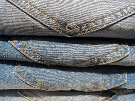 Abstract image of Blue Jeans with design folded and kept one on top of anotherの写真素材