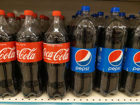 Plastic bottles of Coca Cola and Pepsi kept together on the shelf of a supermarket at Pune, India on 30 August 2021のeditorial素材