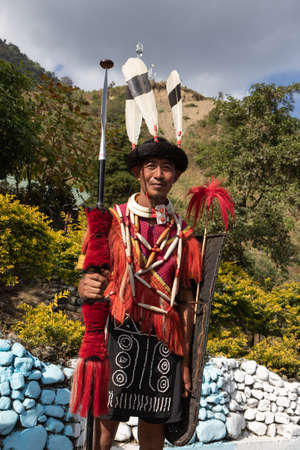 A Naga tribesman dressed in traditional attire with traditional weapons at Kohima Nagaland India on 4 December 2016のeditorial素材