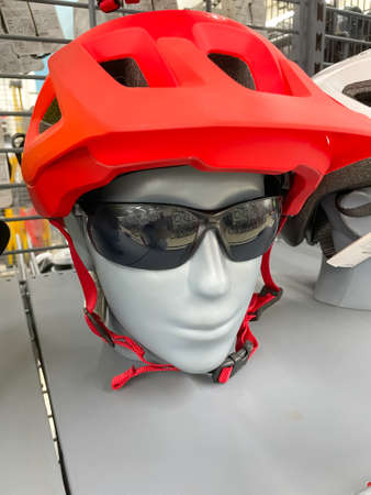 Close up of a mannequin wearing a cycling sports helmet and black sunglassesの写真素材
