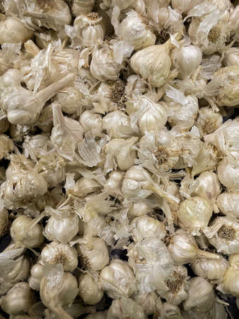 Heap of Fresh garlic cloves kept together in a market shelfの写真素材