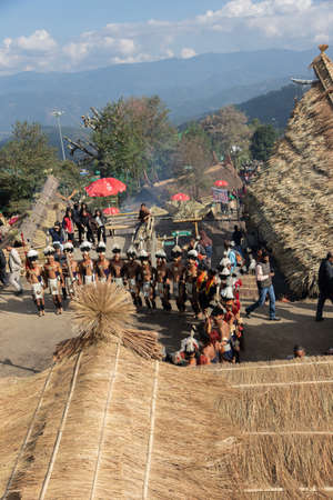 Selective focus image of Traditional dance being performed by tribal men of Nagaland and being watched by Tourists during Hornbill Festival at Nagaland India on 1 December 2016のeditorial素材