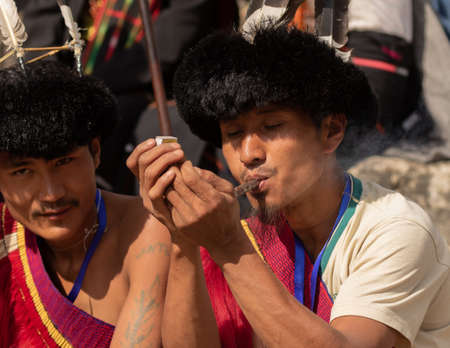 Portrait of a Naga Tribesman dressed in tribal Attire smoking a  pipe during Hornbill Festival in Nagaland India on 2 December 2016のeditorial素材