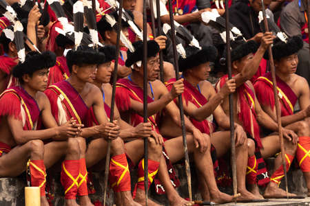 Naga Tribesmen siting dressed in traditional warrior attire during Hornbill Festival in Nagaland India on 2 December 2016のeditorial素材