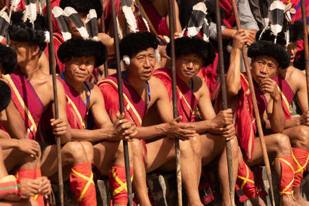Close up image of Naga Tribesmen siting dressed in traditional warrior attire during Hornbill Festival in Nagaland India on 2 December 2016のeditorial素材