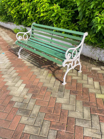 A beautiful siting bench placed in a park with quite and green surroundingsの写真素材