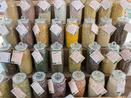 Organic food such as lentils , Tea leaves and dry fruits stored in jars displayed on shelves of a supermarket at Pune India on 3 August 2021のeditorial素材
