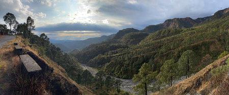Selective focus of a panoramic landscape vista with mountains, river and beautiful cloud formation.の写真素材