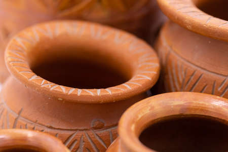 Abstract image of hand made earthen pots with design and pattern on themの写真素材