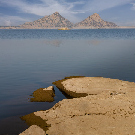 View of pristine landscape of Jawai Dam with hills and clouds in the backgroundの写真素材