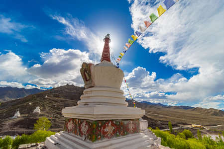 A white Stupa with colorful prayer flags tied on it at Leh, Ladakh India.の写真素材