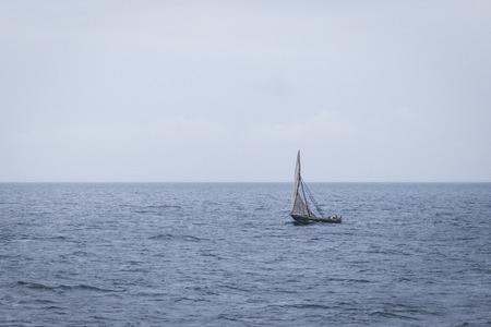 Dhow wooden boat sailing on the Indian Ocean near Zanzibar, Tanzaniaの写真素材