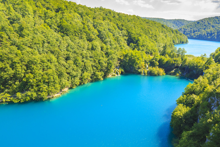 Colorful aerial scenic view on the forest, trees, landscape, blue water lakes and waterfalls of Plitvice lakes, Croatiaの写真素材