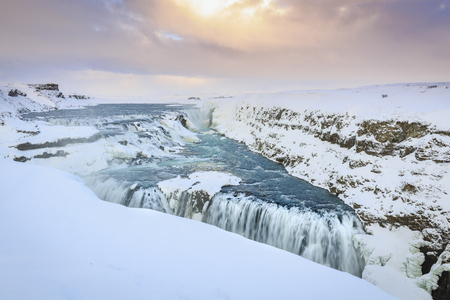 Gullfoss waterfalls located along the golden circle route, Iceland during Winter season. Ice, snow, water and sunset.の写真素材