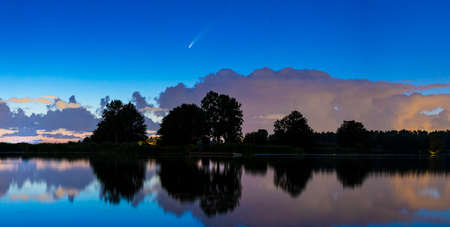 Meteor, shooting star or falling star seen in a night sky with clouds. Comet NEOWISE, C / 2020 F3.