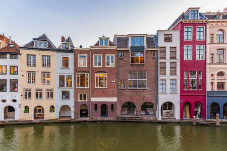 Traditional dutch houses, streets and bridges during dusk. Oudegracht canal, Utrecht city center....
