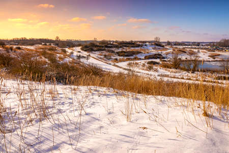 Snowy landscape with hills and meadows under a blue sky in Winter season. Buytenpark Zoetermeer, the Netherlandsの写真素材