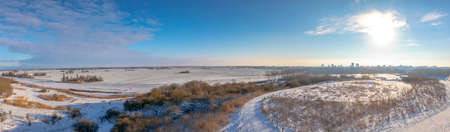 Snowy landscape with hills and meadows under a blue sky in Winter season. Buytenpark Zoetermeer, the Netherlandsの写真素材
