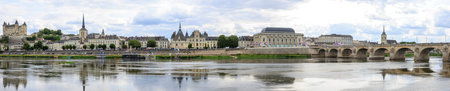 Town of Saumur, France, panorama located at the Loire river under a beautiful cloudscape during...