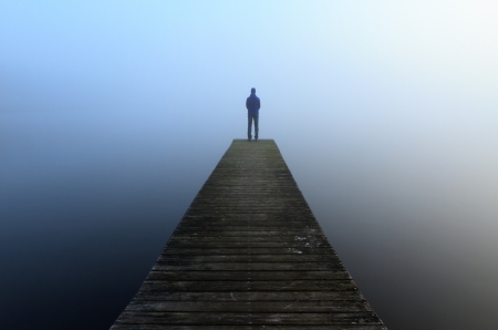 Man at a jetty, staring into the fog の写真素材