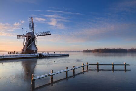 Winter at a windmill in Holland の写真素材