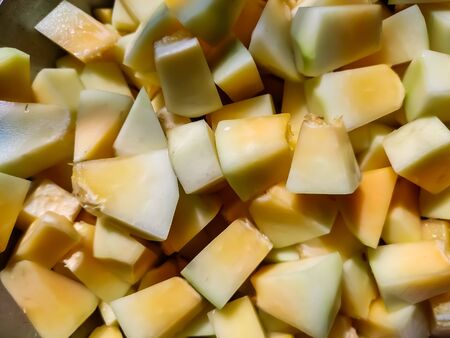 Chopped papaya cut into small pieces close-up shot in the kitchen.の写真素材