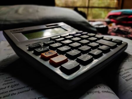 Daylight fall on a white calculator form the window in the daytime.の写真素材