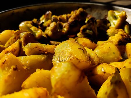 This is roasted cauliflower and roasted potato close-up shot in a indian kitchen.の写真素材