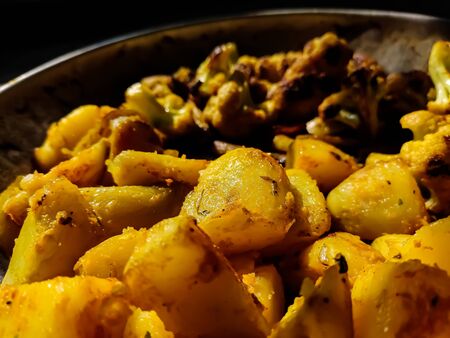 This is roasted cauliflower and roasted potato close-up shot in a indian kitchen.の写真素材