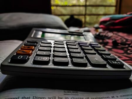 Daylight fall on a white calculator form the window in the daytime.の写真素材