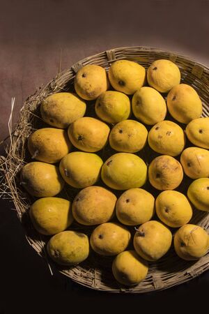 Fresh Mangos arranged in Basketの写真素材