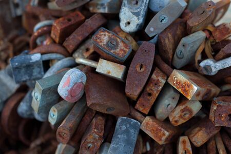 Many of the old, rusty locks, linked togetherの写真素材