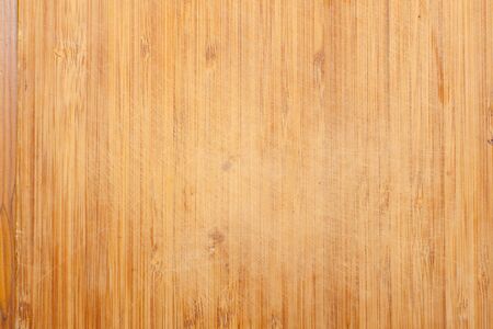 old yellow wooden cutting board from piecesの写真素材