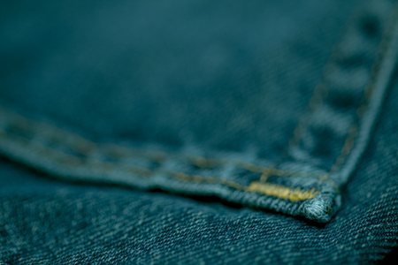 Jeans made of thick blue cloth sewn with white threadの写真素材