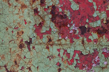 Old green paint over the black paint on metalの写真素材