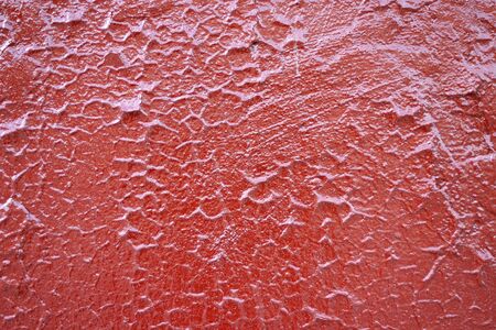 Texture of the old red paint on a small area of the surfaceの写真素材