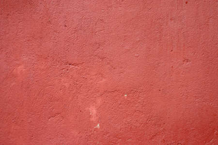 Texture of the old red paint on a small area of the surfaceの写真素材