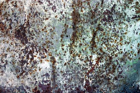 Texture of rusty metal, partially covered with an old blue paintの写真素材