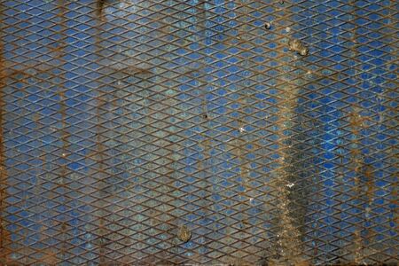 Texture of rusty metal, partially covered with an old blue paintの写真素材