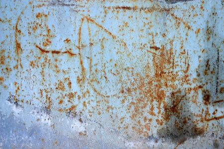 Texture of rusty metal, partially covered with an old blue paintの写真素材
